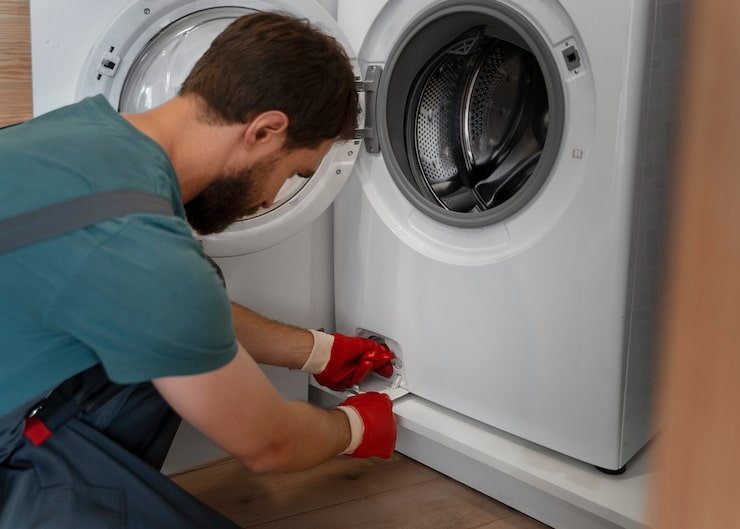 Man repairing washing machine-FixMate Appliance Repair